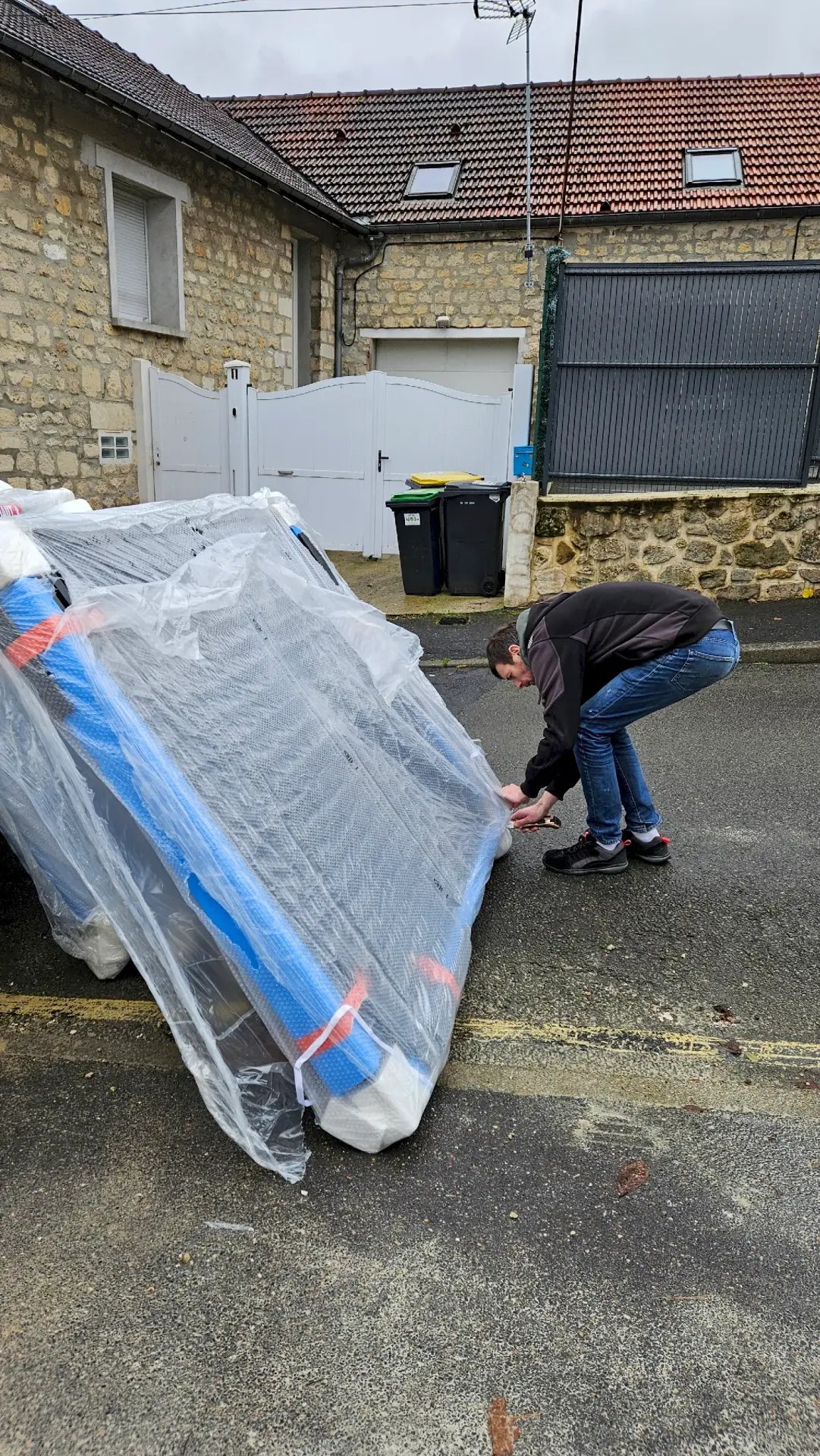 Déballage d'un portail sectionnel aluminium avant installation à Presles 95